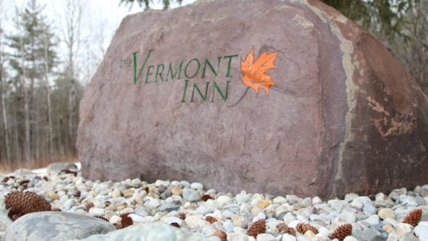 A rock with The Vermont Inn logo