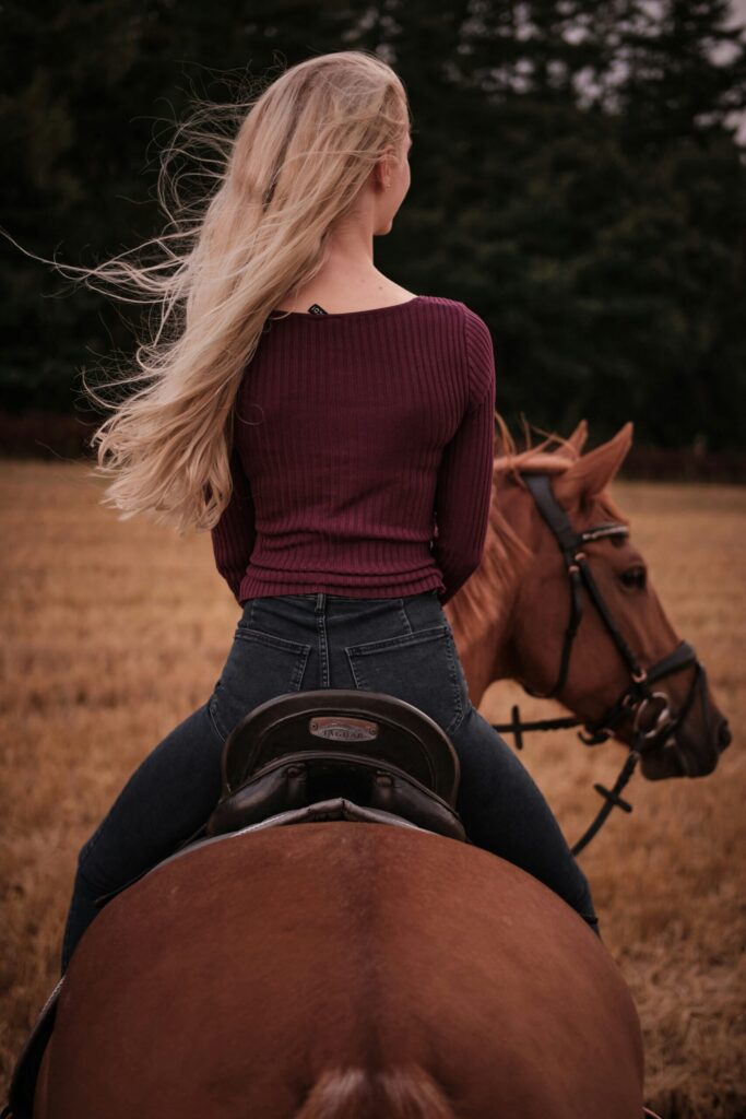 Girl on horseback with hair blowing in wind