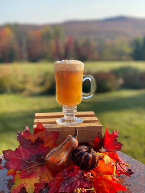 Mug of hot cider wiwth mountains in background